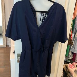 Navy romper with front button and back tie. Has pockets and very comfortable.